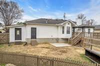 Entrance to the backyard through both the garage and additional storage workshop.