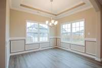 EXAMPLE>>>Spacious Formal Dining Room with Wainscoting, Crown Molding, Tray Ceiling and Tons of Natural Light!