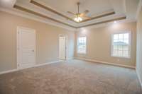 EXAMPLE>>>Large Primary Bedroom Features a Double Tray Ceiling, TWO Large Walk-in Closets, Crown Molding and Recessed Lighting!!