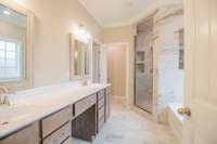 EXAMPLE>>>Primary Bathroom Features a Huge Tile Shower, Soaker Tub, Large Double Vanity with a Cosmetic Area, Tile Flooring, Crown Molding, and a Toilet Room!
