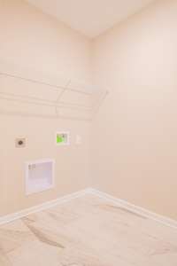 EXAMPLE>>>Spacious Laundry Room with Tile Flooring and Shelving!
