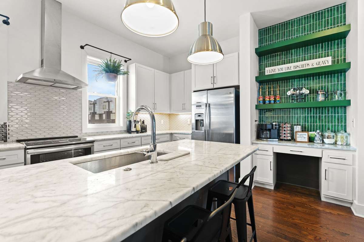 Kitchen island with seating and wet bar/ coffee bar.