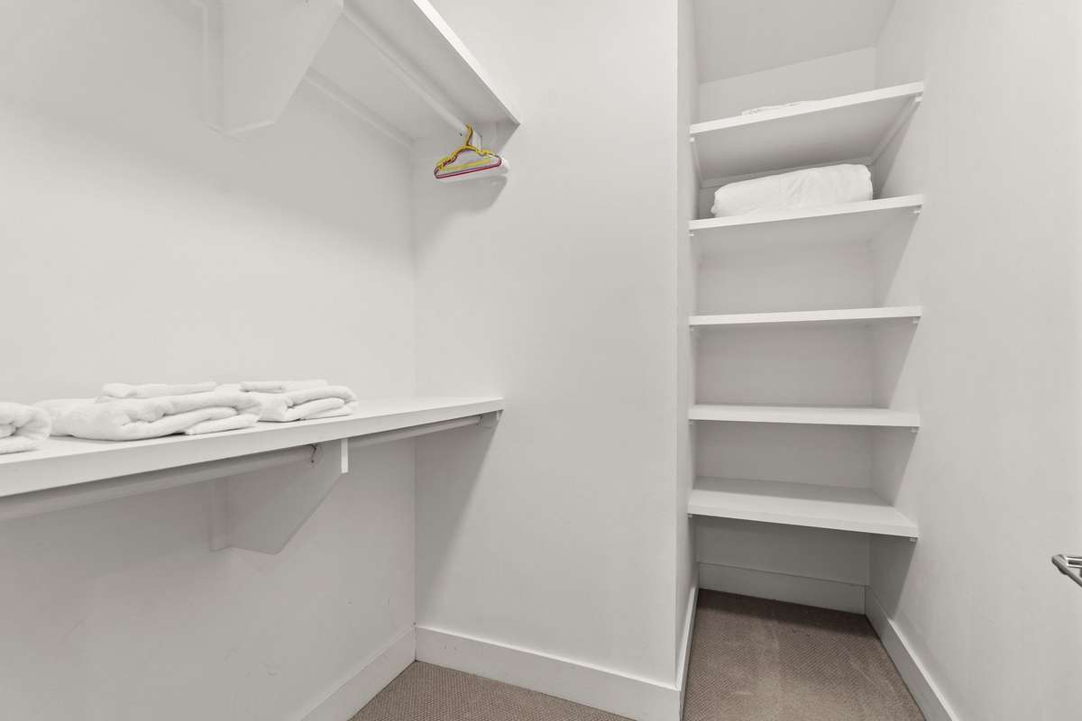 Another huge, walk-in closet with built-in shelving.