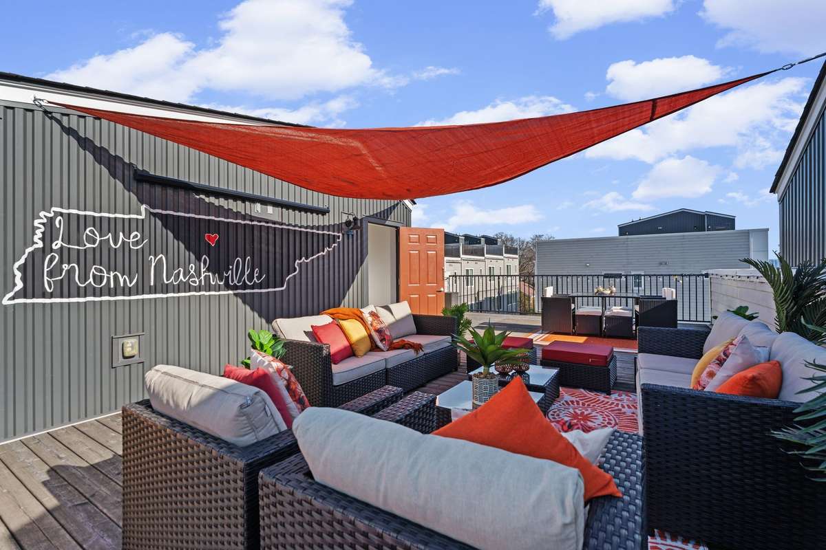 Rooftop deck with seating area, dining space, grill, and games.