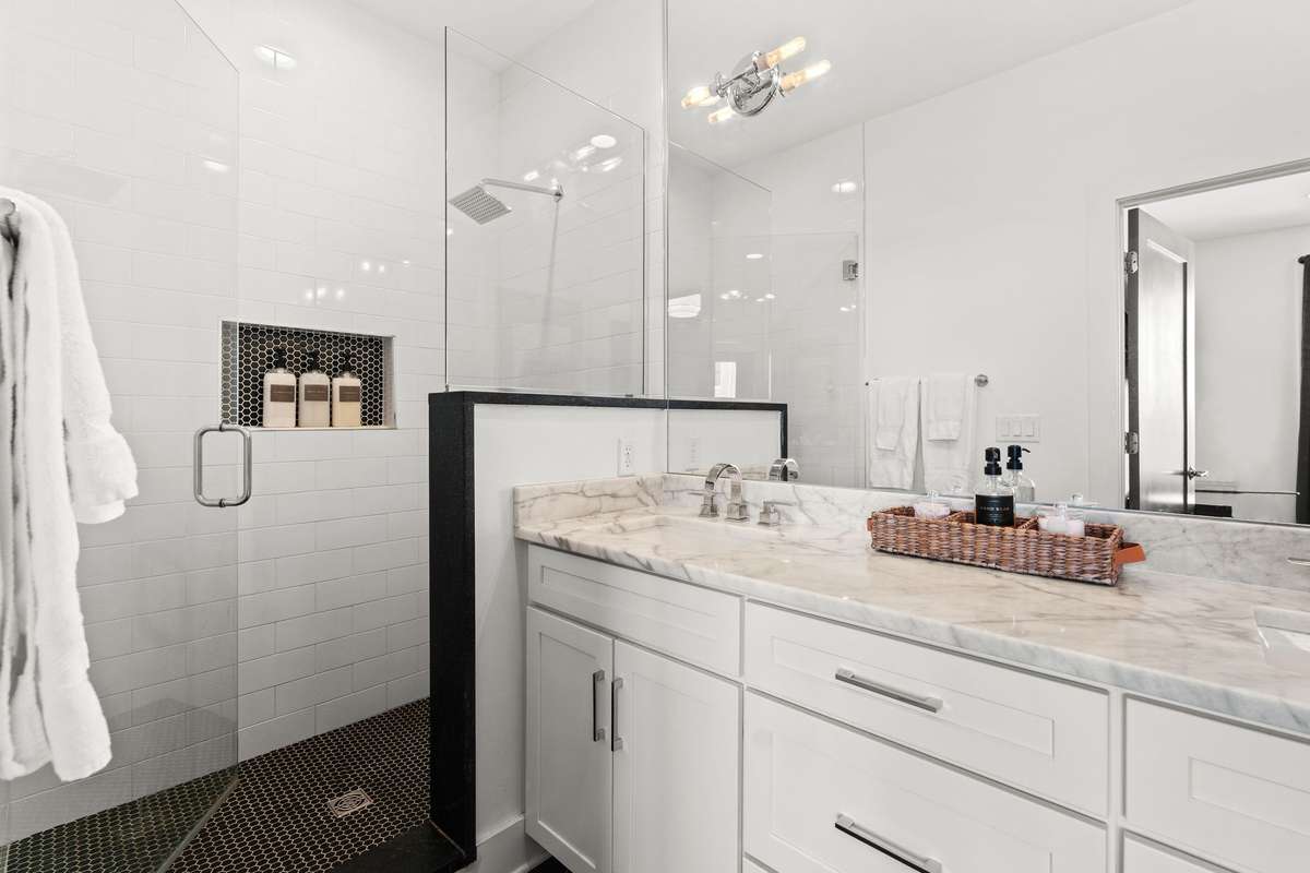Primary bathroom with walk-in shower and double vanities.