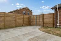 Beautiful new extra tall privacy fence with access gates on both sides.