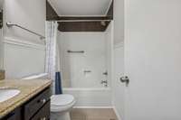 Primary bathroom features a shower/tub combo off the main hall