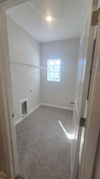 laundry room with upgraded tile