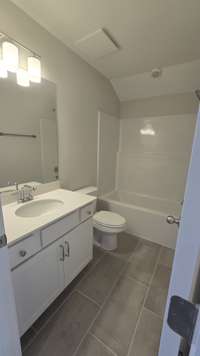 2nd bath with quartz countertops, low maintenance, one piece tub, upgrade tile
