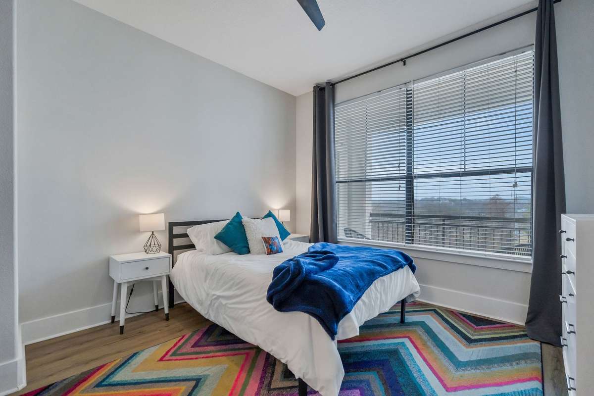 Primary bedroom featuring large windows, natural light, and a closet of your dreams.