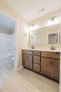 Guest Bathroom has a Large Double Vanity with TONS of Storage & a Separate Shower/Toilet Area!
