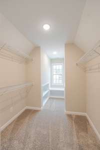 One of the Walk-in Closets, This One Has Built-In Shelving and a Bench!