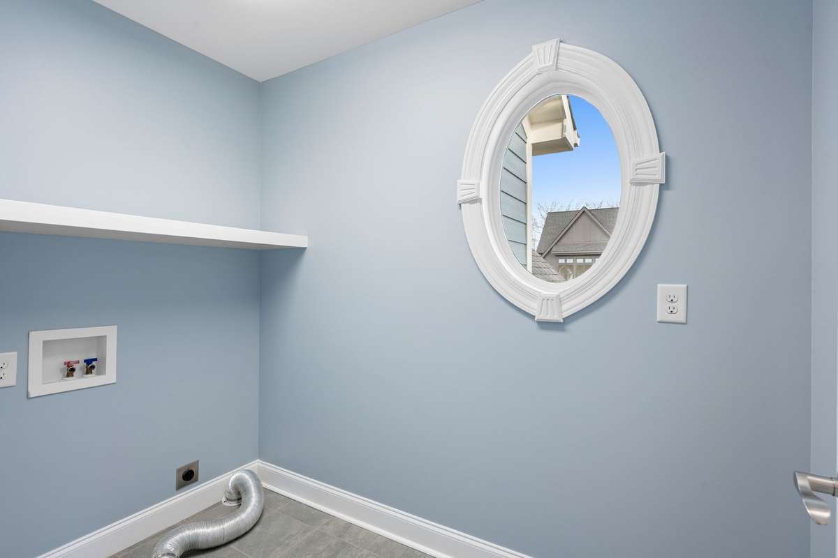 The upstairs Laundry Room is spacious and so very convenient to the bedrooms upstairs...and a beautiful window allows plentiful natural light!