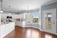 The open kitchen concept features a bay window at the dinette area...
