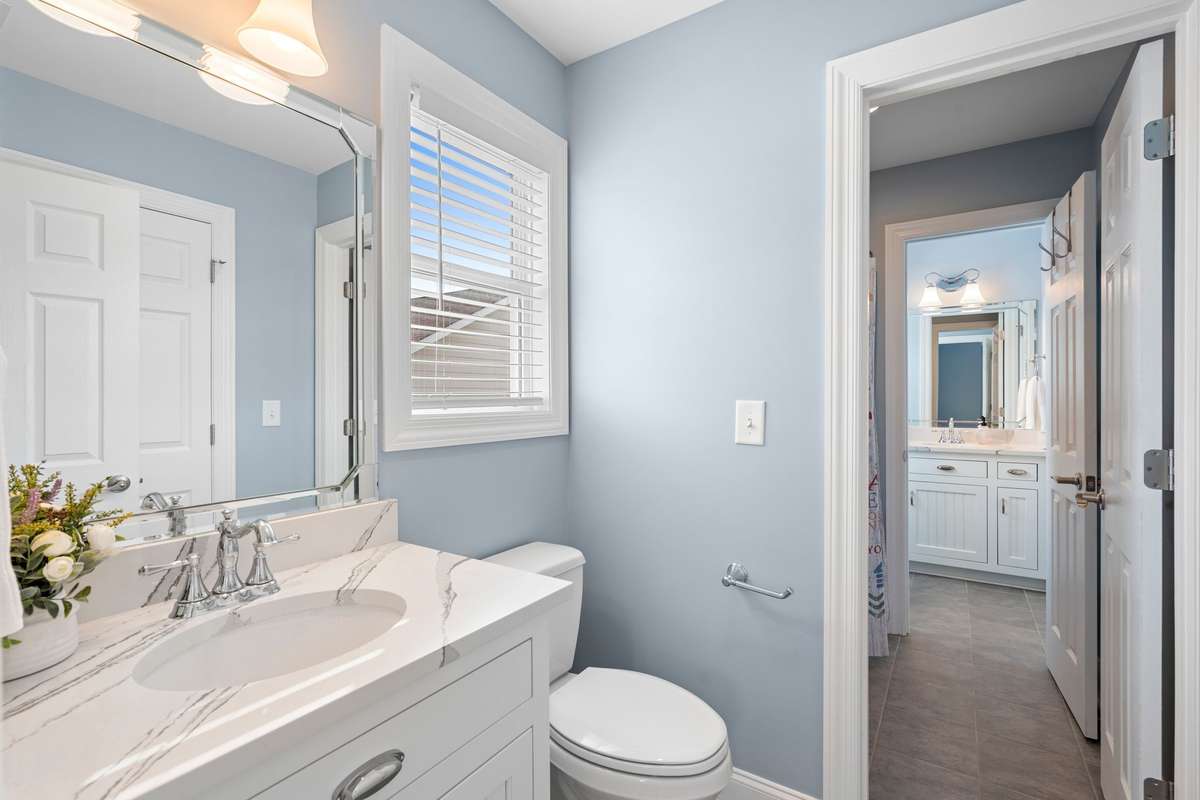 This photo provides a view of the private toilet/vanity space accessible to Bedroom 2...