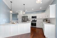 Notice the beadboard cabinetry in this bright, airy kitchen...so crisp and lovely!