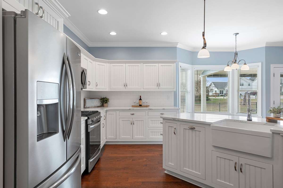 Stainless steel appliances and a porcelain farmhouse-style sink add beauty and style to this kitchen.