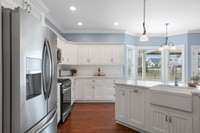 Stainless steel appliances and a porcelain farmhouse-style sink add beauty and style to this kitchen.