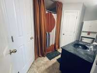 Primary bathroom with combo bath/shower and double closet