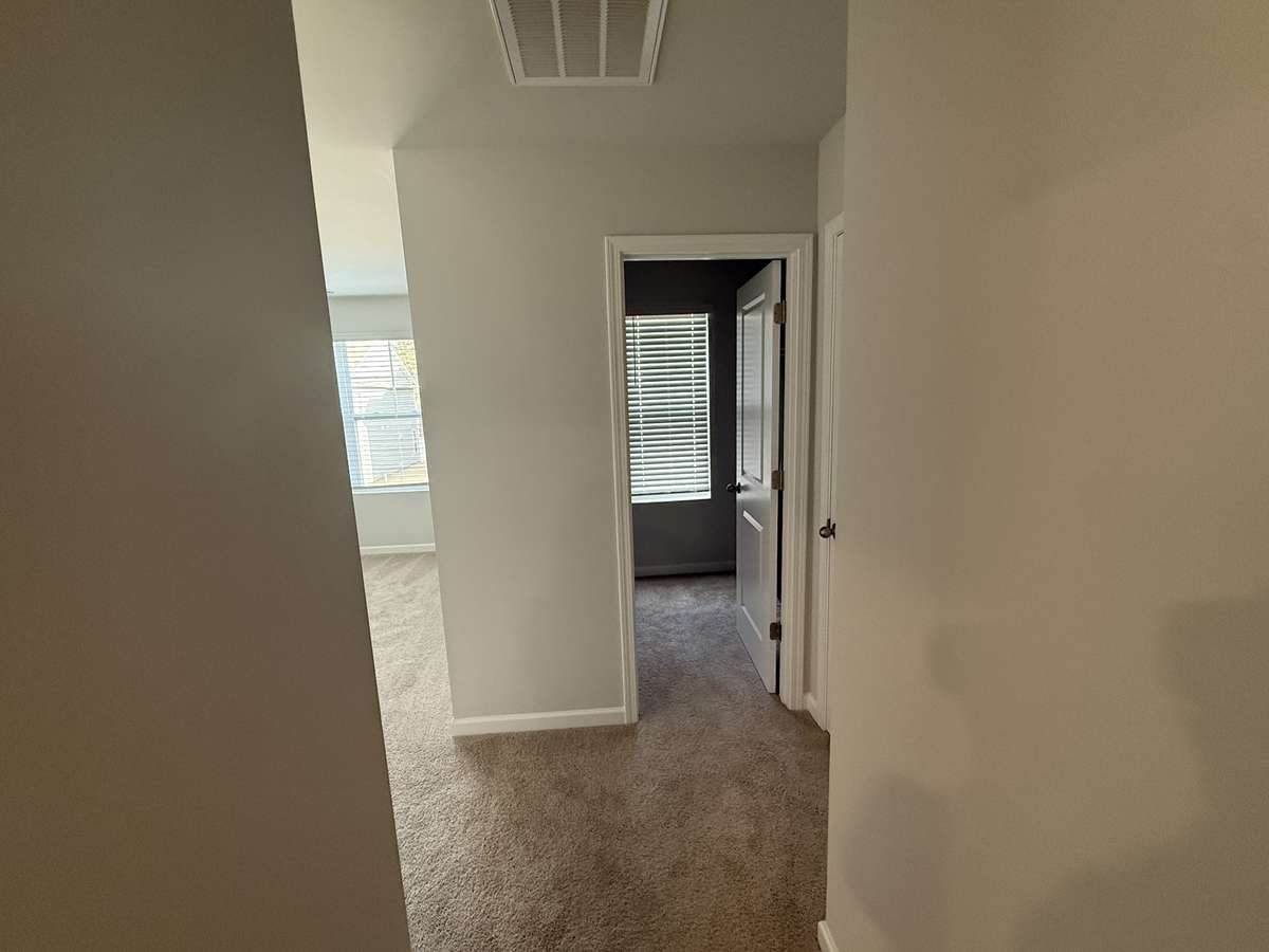 Hallway in primary bedroom looking toward closets.