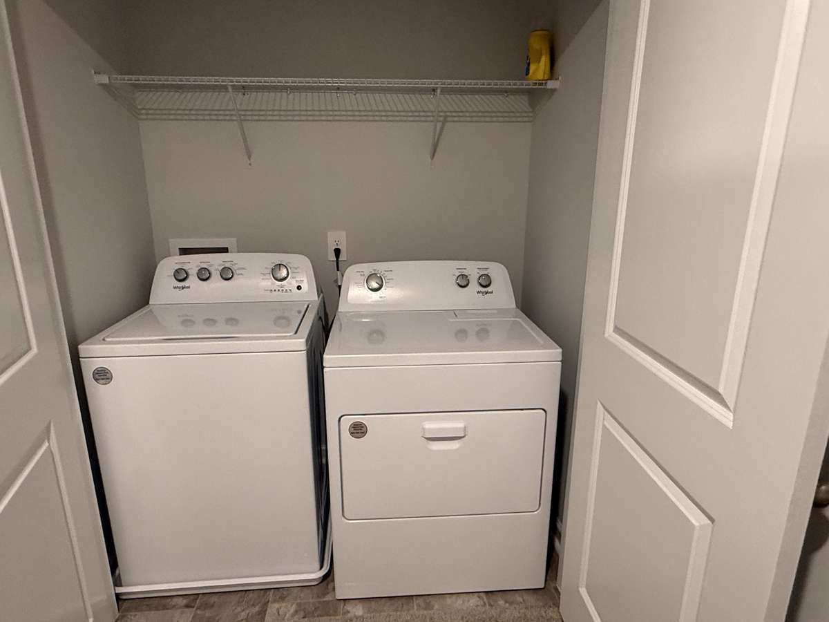 Laundry closet in hallway at the top of the stairway.