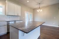 Gorgeous stone with the perfect backsplash to make it all pop! Island is perfect for bar stools for those quick meals!