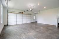 Spacious 2 car garage with pedestrian door