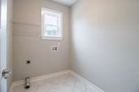 Large laundry room with window allowing natural light that is always welcome in a laundry room!