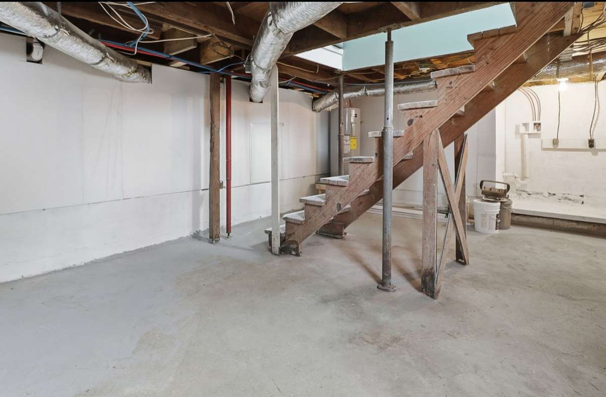 Downstairs you’ll find the laundry area, new hot water heater, and breaker panel. This room features a concrete floor and its own entry/exit door to the back driveway. Plus, separate access to under the home.