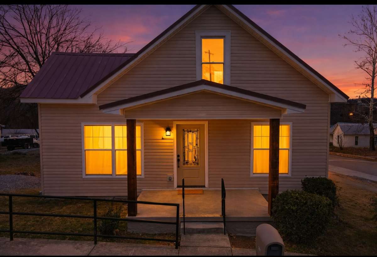 The evening dusk brings a calm to the home. Paired with the view of downtown lights from the side lawn, this home looks as though it could be pictured in a Tomas Kinkade painting.