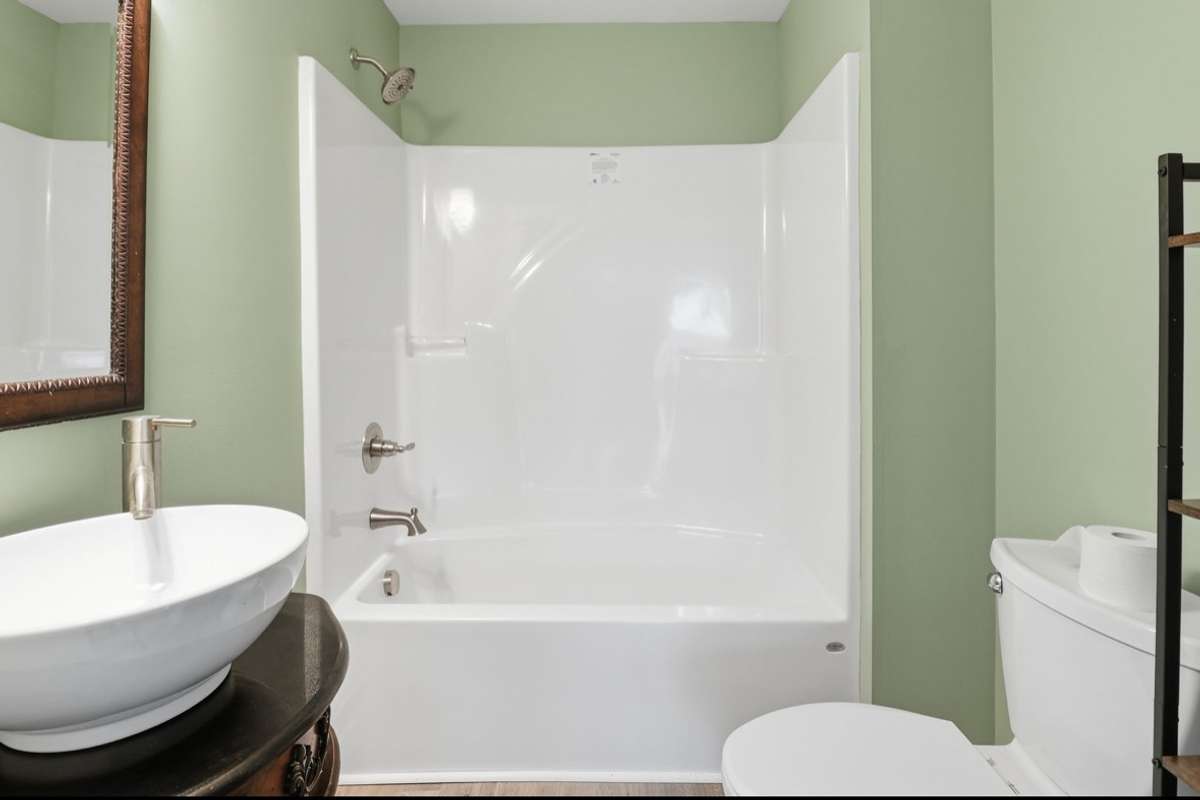 Centrally located, the bathroom has been upgraded with all new plumbing & fixtures. Adorned with a sliding barn door, it is appealing to the eye and full of functionality. The deep shower/tub combo is perfect for a relaxing bath after a days work!