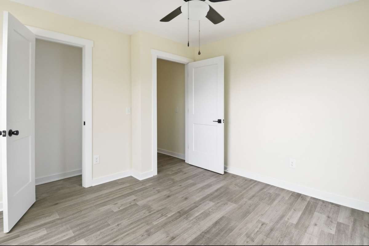 Entry and closet areas of 2nd bedroom. Each bedroom has its own ceiling fan with light and smoke detector.