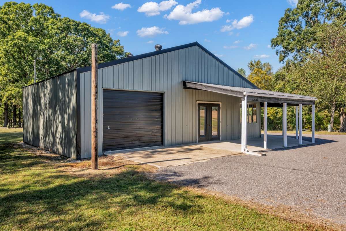 Metal Building with 10' Garage Door & Double Side Doors, With Covered Porch