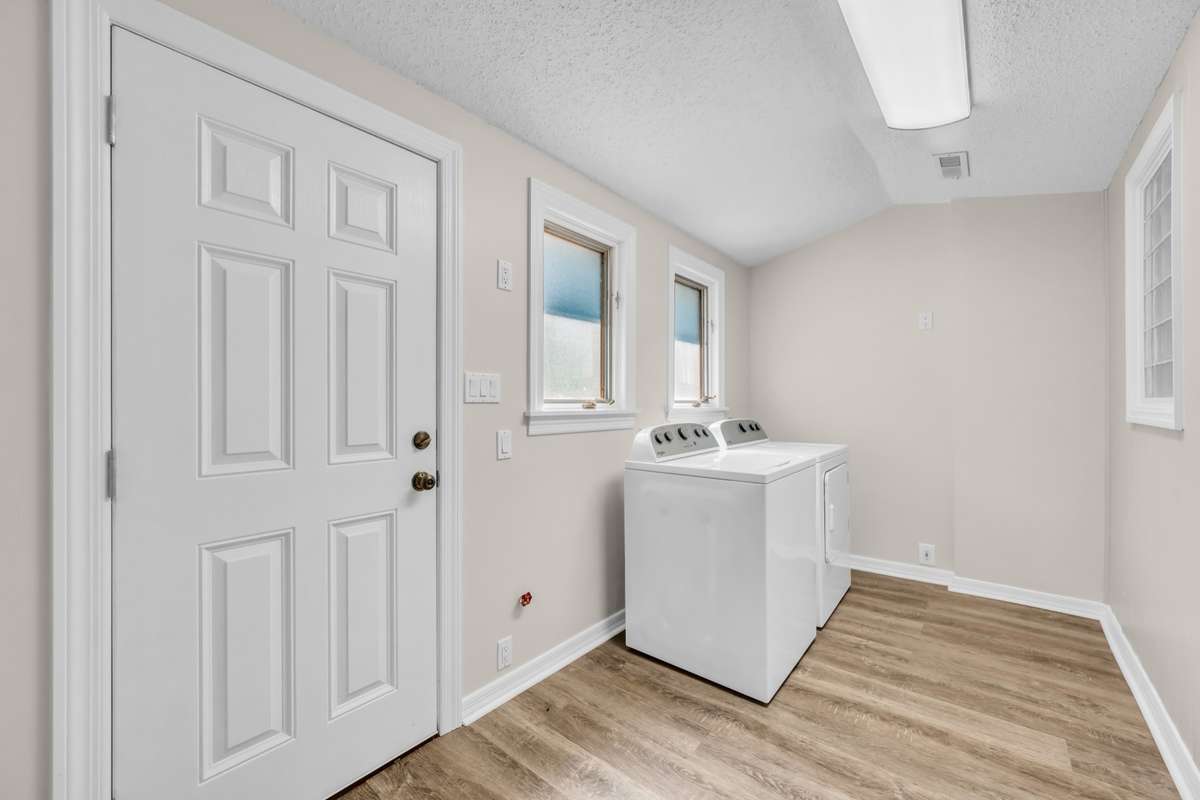 Laundry Room Washer & Dryer to remain. Exterior door to side Deck