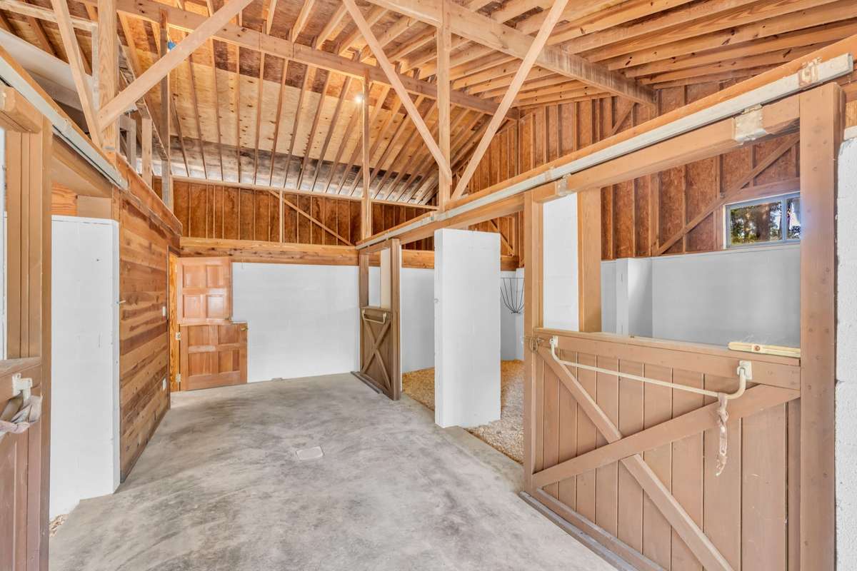 Barn Inside, Two Horse Stalls on Right, One on Left and Horse Washing Bay on Back Left