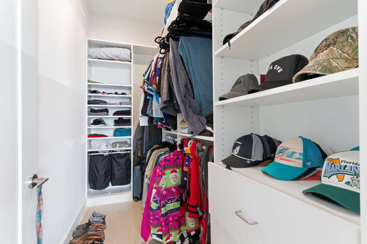 Walk in closet with custom shelving.