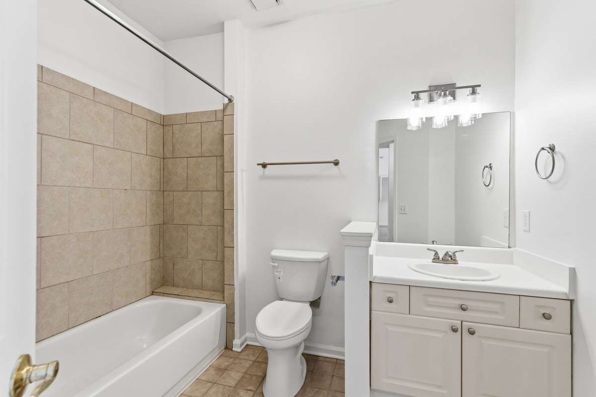 Guest bathroom - freshly painted with a new toilet, large tub/shower and updated light fixtures