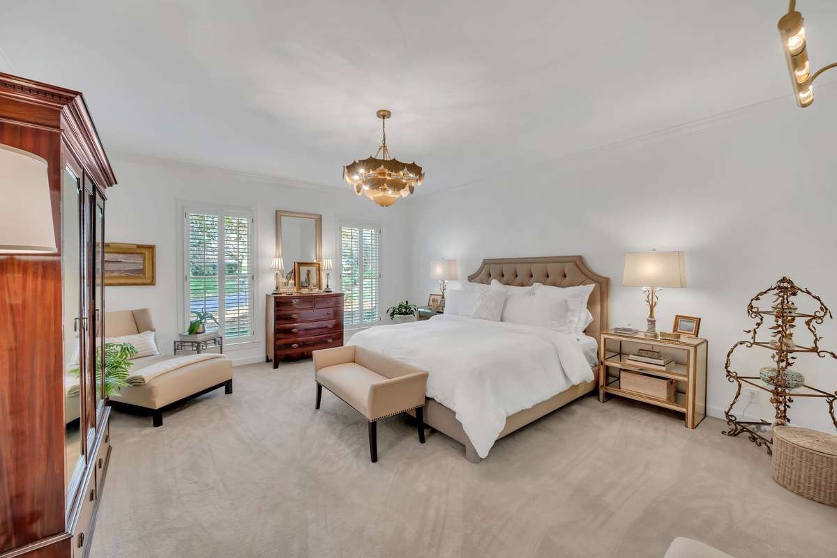 The retreat-like, main floor primary suite includes two walk-in closets and elevated bathroom.
