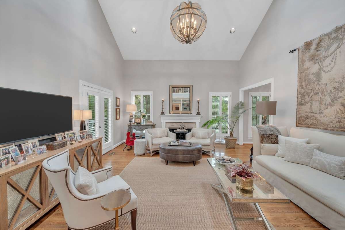 The light filled, two-story living room boasts a gas fireplace and custom built-in bookcases. Flowing out to a spacious deck, with built-in gas supply, the gracious space invites you in.