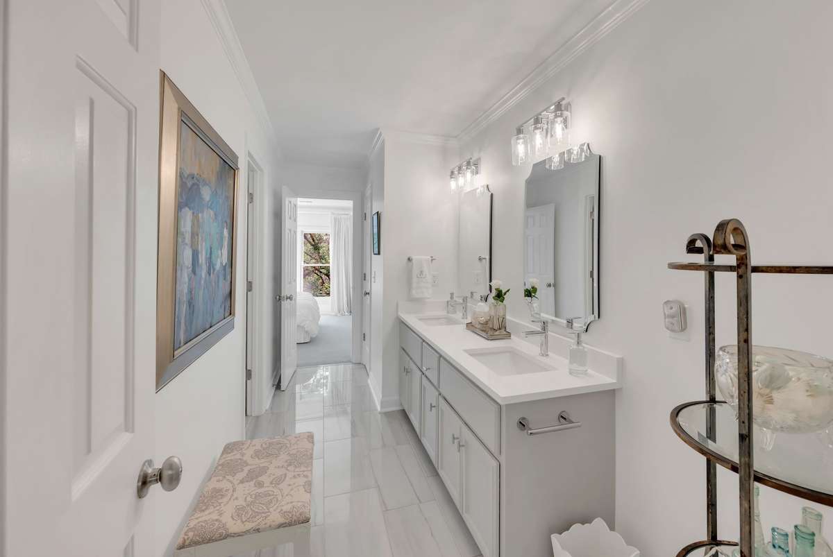 The updated Jack & Jill bathroom, with quartz double vanities, is shared with bedrooms 3 and 4