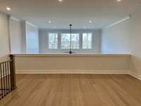 Spacious Gameroom w/ large windows and view of the tree line & farmland behind the unit