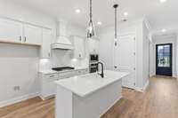 Large island to seat 4-5 plus a cabinet garbage pullout, pantry, and soft closing doors and drawers