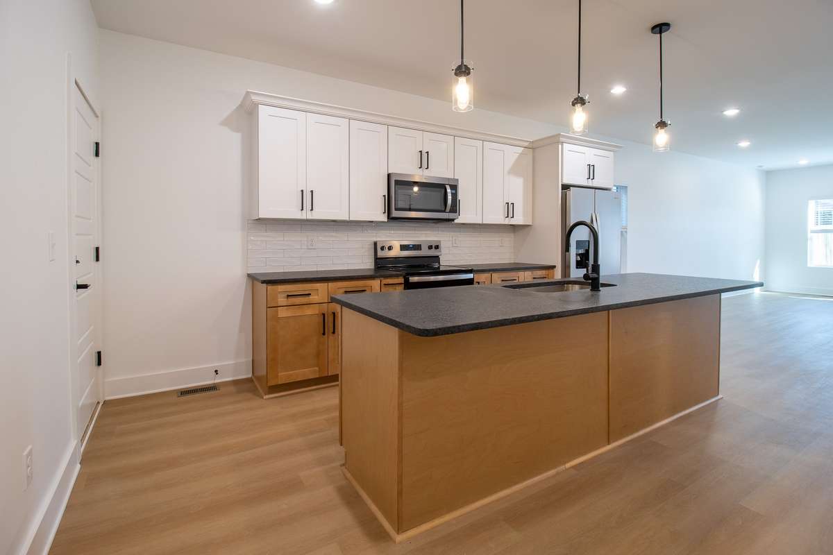 A spacious kitchen with over-sized island is the perfect place for cooking and gathering.