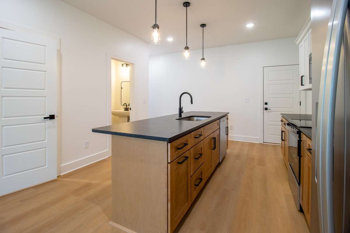 Upgraded leathered granite counter tops add a touch of warmth, and a full stainless steel appliance package completes the kitchen.