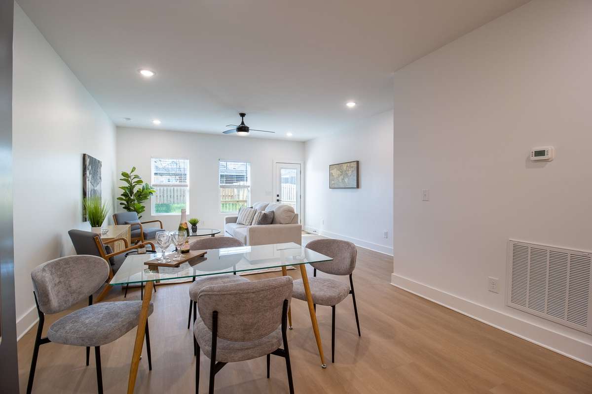 The kitchen is open to the dining area, where there's plenty of space for everyone at the table!