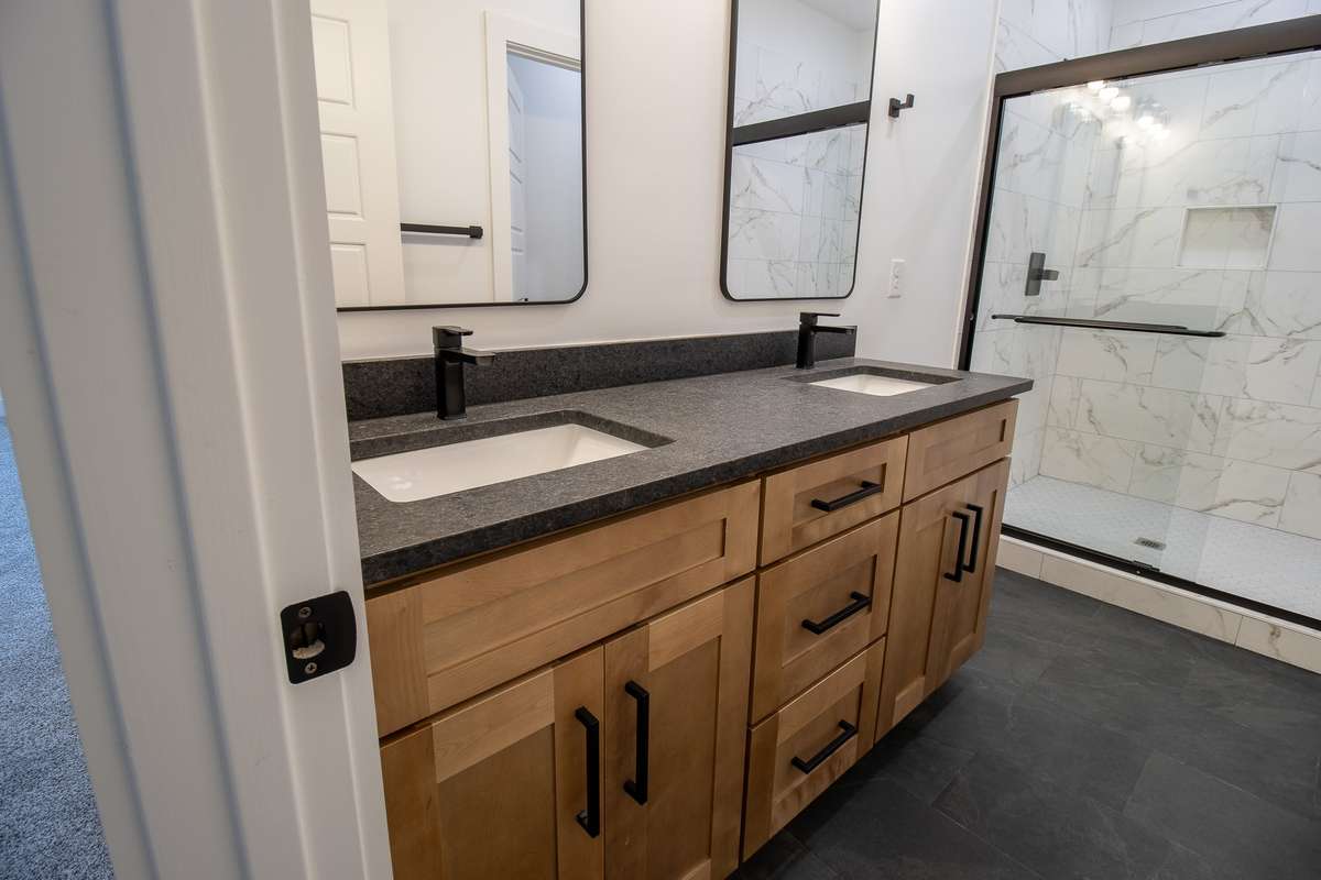 With dual vanities and tiled shower, the primary bath is as stylish as it is functional.