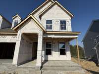 ***Photo taken 10/18/25 to show current status of construction***

Perfect for seating and seasonal décor, the front porch offers curb appeal and a cozy spot to connect with neighbors.