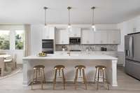 ***Photo From Winters Model Home - Options May Vary***

This stunning gourmet kitchen is a masterpiece of design and functionality, with stainless steel appliances, white cabinetry, quartz countertops, and a center island perfect for entertaining.