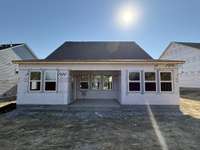 ***Photo taken 10/18/25 to show current status of construction***

Step outside to the covered rear patio, ideal for year-round outdoor living and entertaining. Offering shade and shelter, this space provides the perfect setting for relaxation.