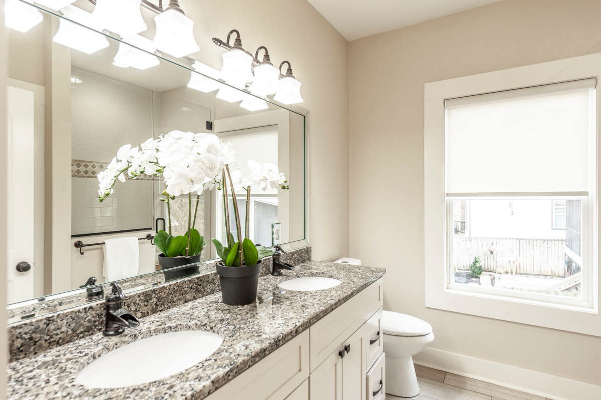 The primary bathroom features elegant tile floors and a spacious, well-designed layout.